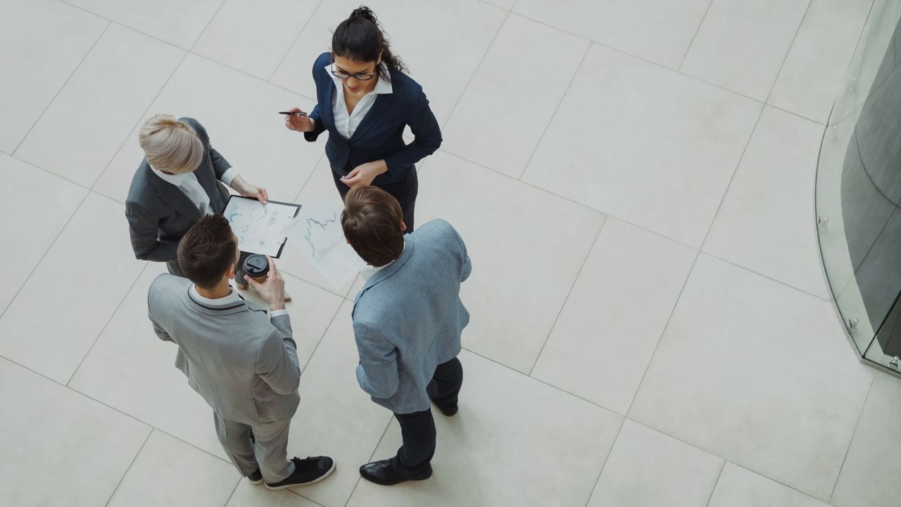 Services Group of business professionals collaborating in an office setting.