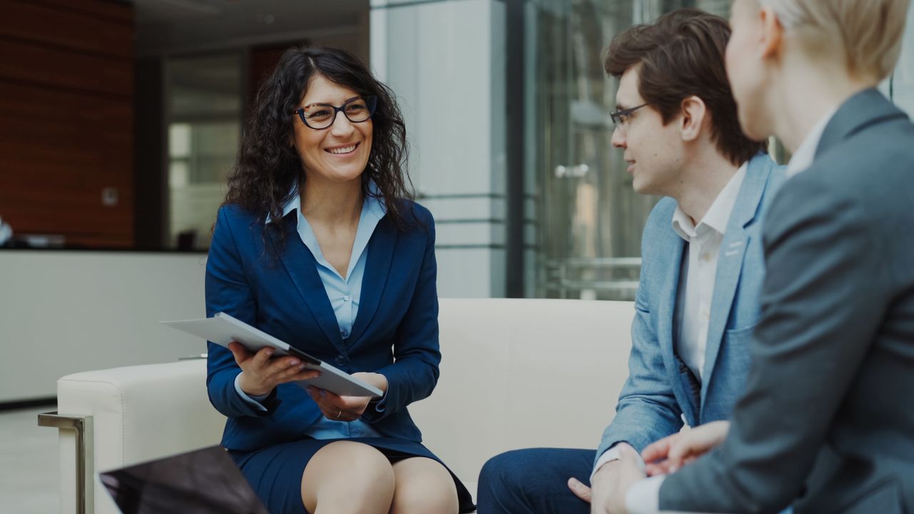 About Professionals discussing business strategy in a corporate office setting.